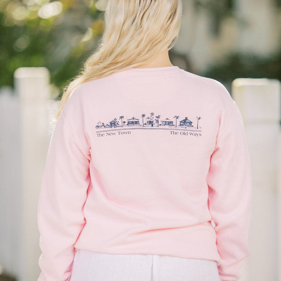 Blossom pink Unisex Seaside Sweatshirt back showing Seaside townscape in Navy. New town old ways