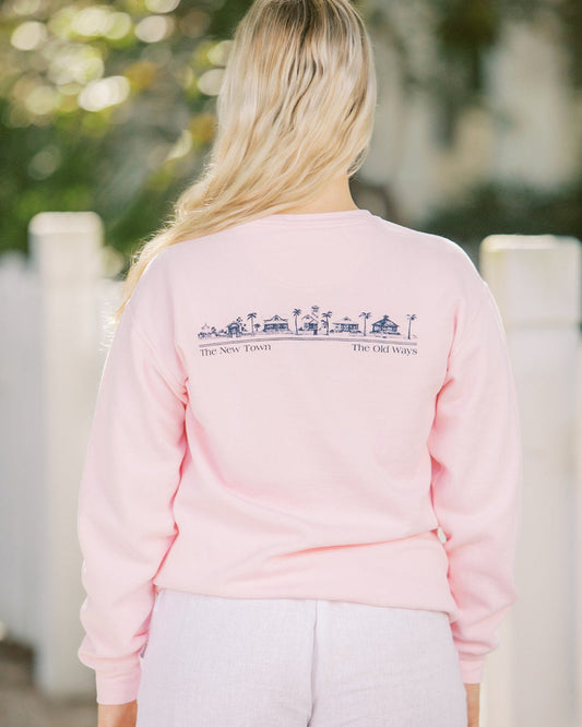 Blossom pink Unisex Seaside Sweatshirt back showing Seaside townscape in Navy. New town old ways