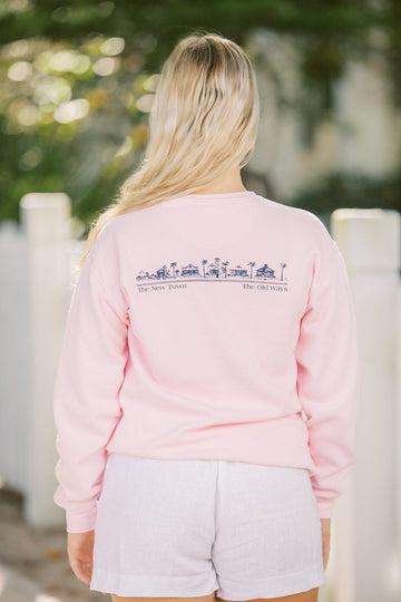 Blossom pink Unisex Seaside Sweatshirt back showing Seaside townscape in Navy. New town old ways