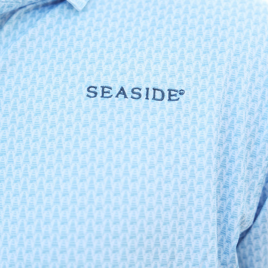 Close-up of a light blue coleman pavilion patterned button-down shirt with 'SEASIDE' embroidered in navy on the chest.