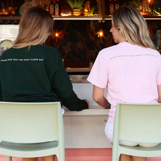 Green Lightweight Unisex Seaside Sweatshirt and pink tee back where bare feet and sandy floors rule