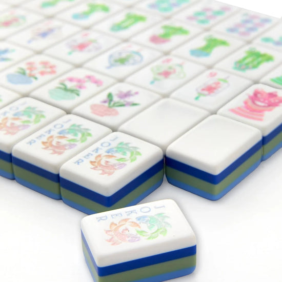 Set of colorful mahjong tiles with floral designs on a white background