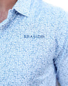 Close-up of a light blue and white patterned button-down shirt with 'SEASIDE' embroidered on the chest, worn by a model.