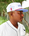 Side view showing Seaside Post Office illustration on white five-panel hat