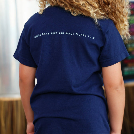 Youth Navy Blue Colors of Seaside Rainbow Tee Back with tagline "where bare feet and sandy floors rule"