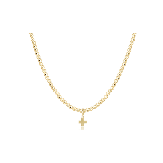 A delicate gold chain necklace with a small cross pendant, displayed against a solid white background.