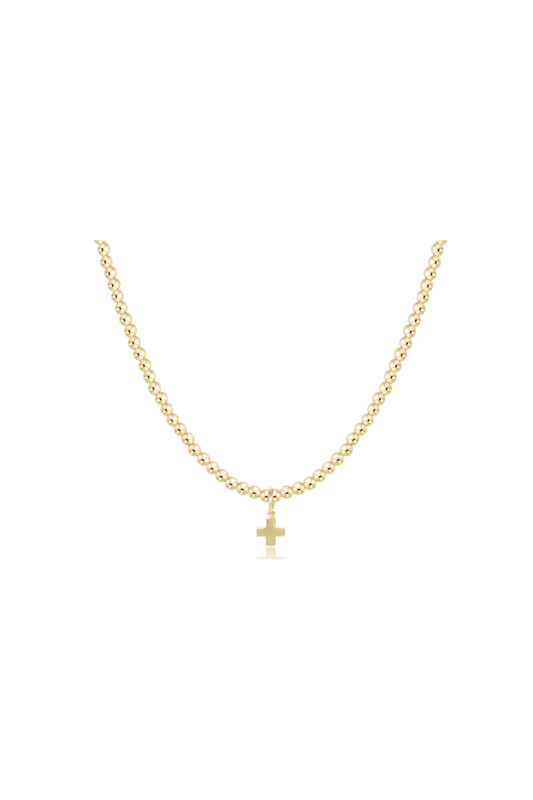 A delicate gold chain necklace with a small cross pendant, displayed against a solid white background.