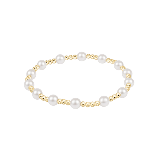 A delicate gold chain bracelet with a short, textured gold bead segment pendant, displayed on a clean white background with a soft reflection below.