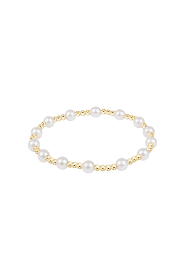 A delicate gold chain bracelet with a short, textured gold bead segment pendant, displayed on a clean white background with a soft reflection below.