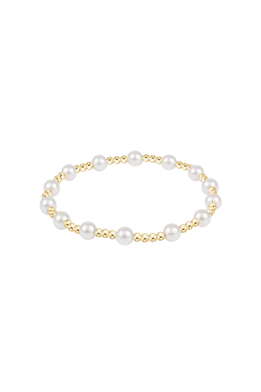 A delicate gold chain bracelet with a short, textured gold bead segment pendant, displayed on a clean white background with a soft reflection below.