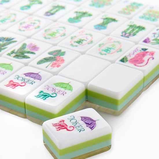 Decorative mahjong tiles with colorful designs on a white background