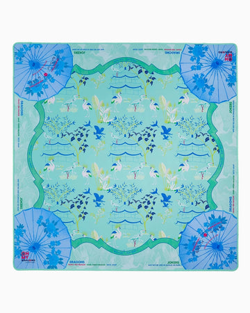 Decorative mahjong mat with floral and umbrella design on a light blue background